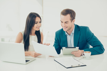 Two young business people working on new important contract