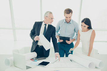 Portrait of concentrated engineers thinking about best way to en