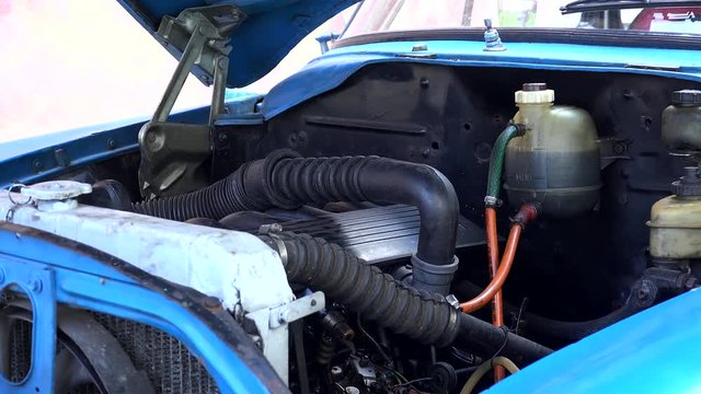 Redesigned engine under the open hood of an old american car. Havana