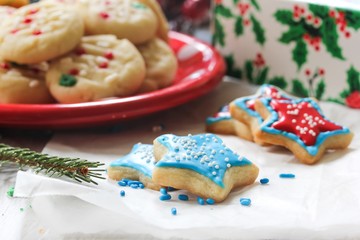 Xmas star shaped cookies  with red and blue royal icing on holiday background, selective focus