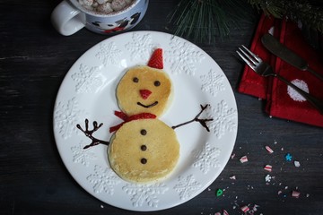Snowman Pancakes for kids on dark moody background