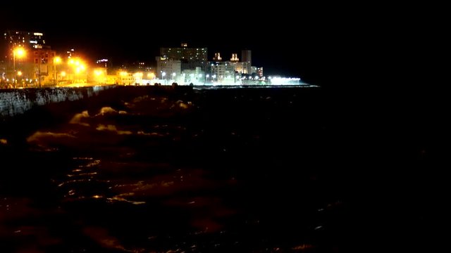 Big waves at the Havana Malecon by night. Cuba