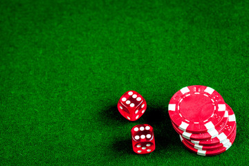 poker chips and dice on green background top view