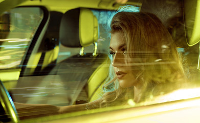 Attractive young woman sitting behind the wheel