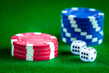 stack of chips play poker on green background close up