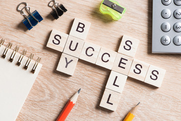 Conceptual business keywords on table with elements of game making crossword