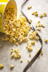 Obraz na płótnie Canvas watching movie with popcorn on gray background close up