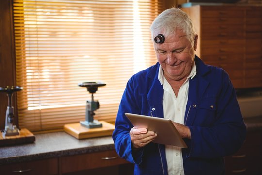 Horologist using digital tablet - Powered by Adobe