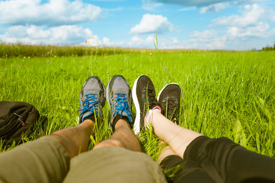 Couple's feet relaxing outdoors. 