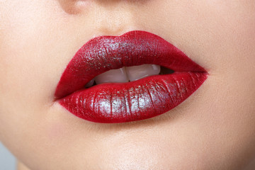 Beautiful female with red shiny lips closeup,macro photography