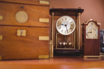 Pendulum clock watch on table