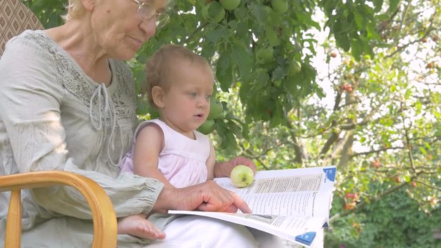 Grandma showing baby pictures in the book.