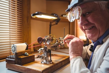 Horologist repairing a watch in the workshop