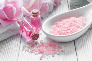 organic cosmetic with rose oil on wooden background close up