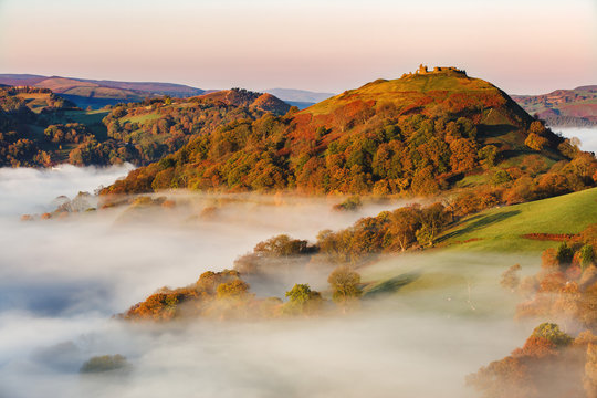 The medieval castle Dinas Bran standing above the mist and fog on an autumn morning, Denbighshire, Wales