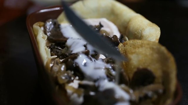 Chef pouring sauce to al forno pancake
