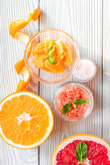 organic cosmetic with citrus on wooden background top view