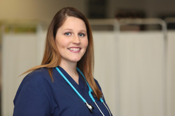 Portrait of a young attractive female healthcare professional, woman nurse in medical clinic.