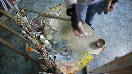 Artist working on painting.