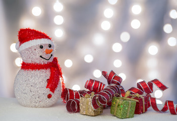 Snowman with gift packages and ribbons.