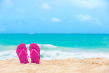 Fototapeta na wymiar Pair of sandals on the beach. Beach holidays concept. 