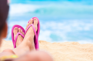 Female's feet relaxing on the beach. 