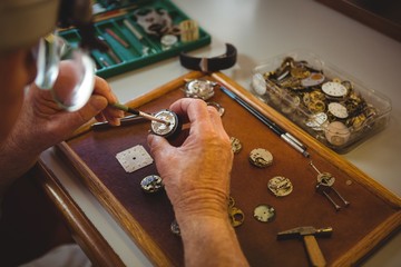 Horologist repairing a watch