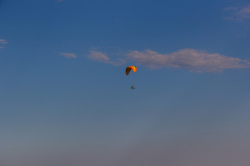 Naklejka na ściany i meble A single paraglider flying over the mountain Toratau