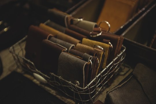 Various leather wallet in steel crate