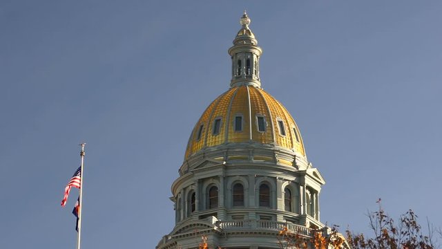 The US and State flags fly at Denver's Capital