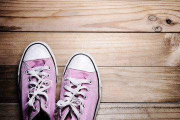 Pink shoes sneakers on a  wood