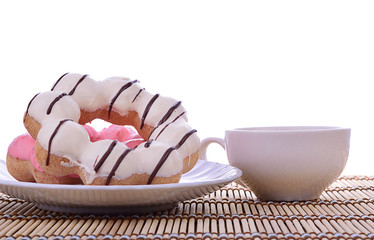 Desk donuts with   tea cup. Isolated on white background.