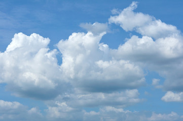 Blue sky with fluffy cloud for background.