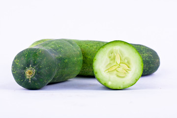  green cucumbers and half cucumbers  have full vitamin on white background healthy vegetable food isolated
