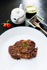 Delicious beef steak on stone background, close-up..