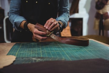 Craftswoman working on a piece of leather