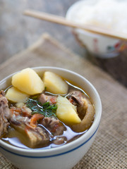  the potato soup with pork on the wood.