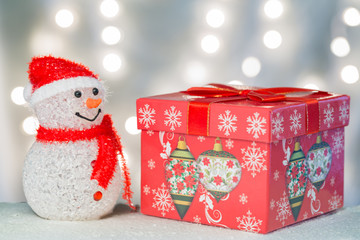 Snowman with huge gift box.