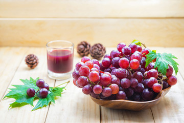 Fresh red grapes isolated on wooden background...
