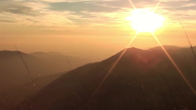 Fiery sunset from mountain pick with thin glazes in the sky evening. Fall season. Orobie alps. Rena pick. Bergamo Italy. 