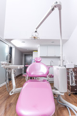 Dental office with pink dental chair..