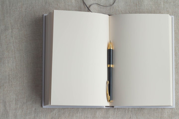 A white book and a pen