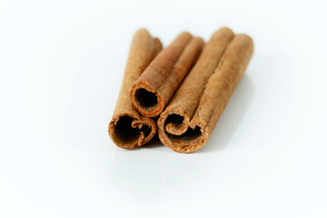 Dried cinnamon on white background