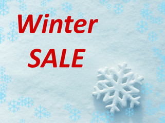 Snowflake and text WINTER SALE on snow background