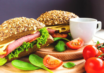 Burger sandwich with ham, cheese, tomatoes and lettuce
