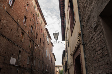 narrow street and old houses in Siena
