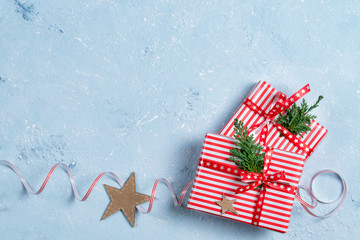 Christmas background with gift boxes and decorations, blue stone table, top view
