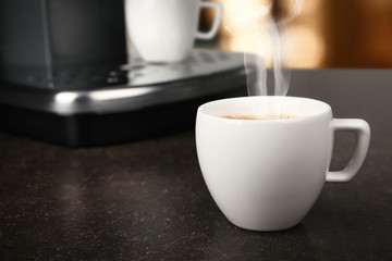 Cup of aromatic coffee on table, closeup