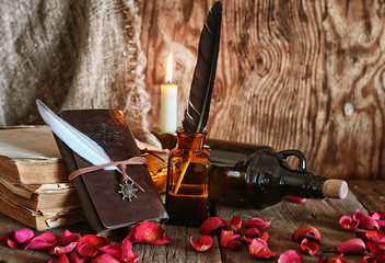 feather and book novel close to the a candle