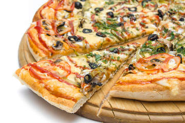 large pizza with one piece on a wooden board